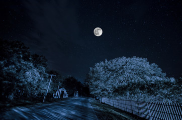 Beautiful night landscape of big full moon rising over the mountain road with hill and trees. Forest and mountains of south part of Azerbaijan. Masalli Yardimli