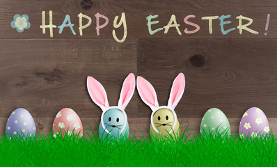colorful pastel easter eggs with bunny ears on wooden background, promotional sign with text happy easter