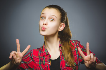 coquettish girl. Closeup Portrait handsome teen smiling isolated on grey