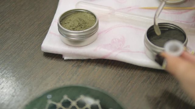 Barbershop. Preparation of paint for the eyebrows. Close-up.