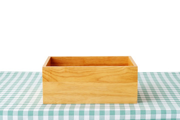 Empty wooden storage box on green checked tablecloth isolated on white background, product display montage