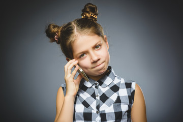 Portrait of offense girl with mobile or cell phone. Negative human emotion
