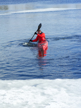 man kayaking on a red kayak on excursions in nature