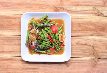 yardlong bean salad with crab of thai foods in white dish on wood background, SOMTUM.