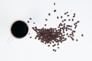 Cup of black coffee in a white mug with coffee beans