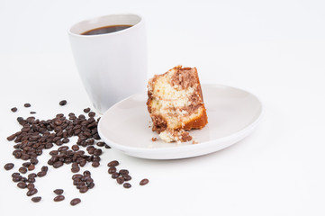 Cup of coffee and coffee beans with a piece of cake