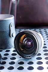 Vintage manual photographic camera lens on metalic background