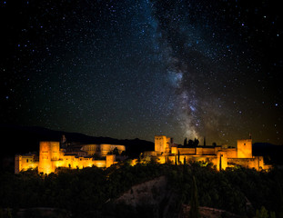 Ancient arabic fortress of Alhambra at night, Milky way. Granada, Spain. - obrazy, fototapety, plakaty