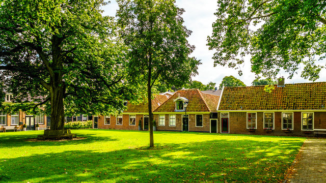 Courtyard with grass and old Oak and Chestnut Trees in the historic village of Midden Beemster in the Beemster Polder in the Netherlands