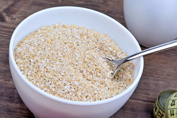 Bowl with oat and centimeter on table