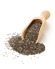 Whole dried black chai seeds in wooden scoop