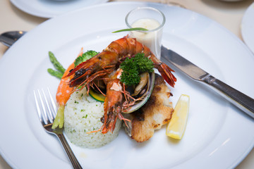 Pan Sear Sea bass, Tiger Prawn, NZ Mussel, Garlic Rice with Market Vetetable and Cream Leek Sauce