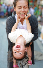 Happy loving family. mother hugging her child with funny face