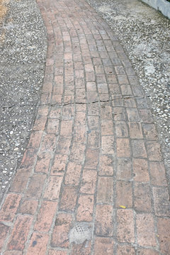 An old garden walkway constructed of bricks and mortar.