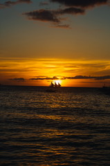 Fototapeta na wymiar Beautiful golden sunset over fishing boats on the sea