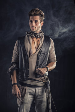 Good Looking Young Man in Pirate Fashion Outfit on Gray Background. Captured in Studio.