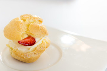 Homemade, Homemade cake, Choux Cream with fresh blueberry and strawberry decorated on white background at house.