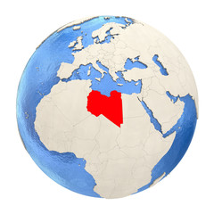 Libya in red on full globe isolated on white