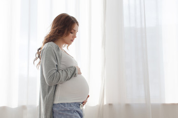 Pregnant woman touching belly