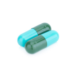 Two capsule color green and blue isolated on white background