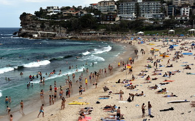 Sydney, Australia - Feb 5, 2017. People relaxing, swimming and sun bathing on Bronte beach.