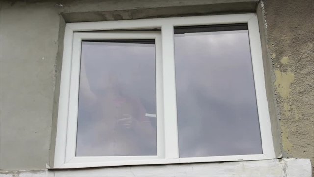 woman behind a window in the room/woman through window