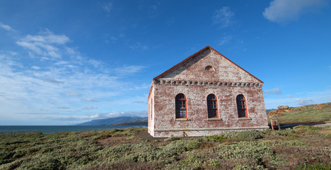 Fototapeta premium Red Brick Fog Signal Building at the Piedras Blancas Lighthouse on the Central California Coast US