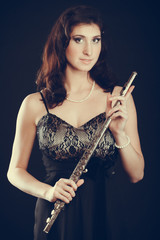Elegant woman with flute instrument.