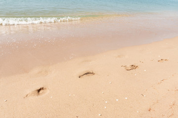Fototapeta na wymiar Footprints on sand of beach