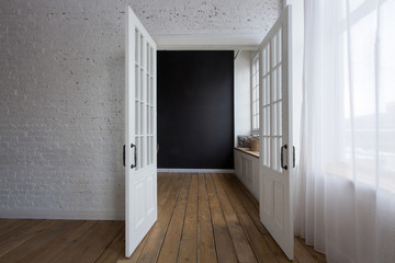 Opened white doors in empty room