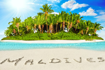 Whole tropical island within atoll in tropical Ocean and inscription 