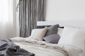 Bed with white and grey linens