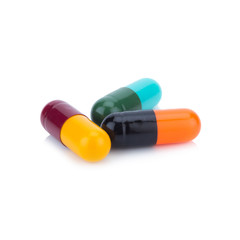 Three capsule color Red Yellow Blue Green Orange and Balck isolated on white background