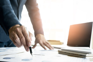 Team work process. young business managers crew working with new startup project. labtop on wood table, typing keyboard, texting message, analyze graph plans
