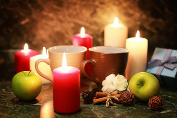 night cup of tea with candle and apple