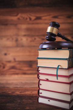 stack of law books with judge's gavel on top