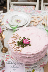 Pink wedding cake with rose on the top 