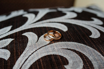 Gold wedding rings on Brown fabric