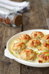 Meatballs in a white sauce. Food Photography. Wooden background.