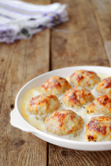 Meatballs in a white sauce. Food Photography. Wooden background.