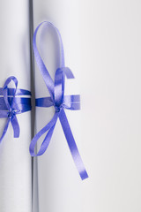 Rolled diploma or paper  with blue ribbon 