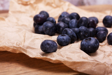 Fresh blueberries on a rustic brown paper background