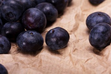 Fresh blueberries on a rustic brown paper background