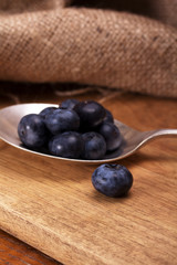 Blueberries and spoon on a rustic background