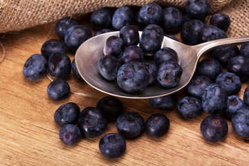 Blueberries and spoon on a rustic background