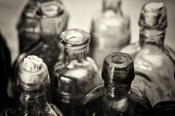 Coloured glass bottles on a rustic background