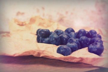 Fresh blueberries on a rustic brown paper background