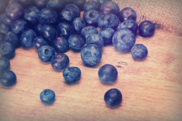 Split blueberries on a rustic wooden background