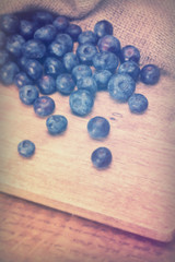 Split blueberries on a rustic wooden background