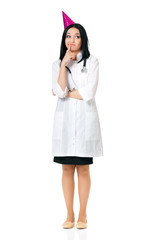 Young female doctor wearing birthday cap, isolated white background